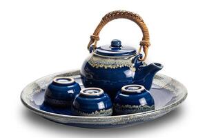 Side view of blue ceramic tea set with cups in a tray isolated on white background with clipping path. photo