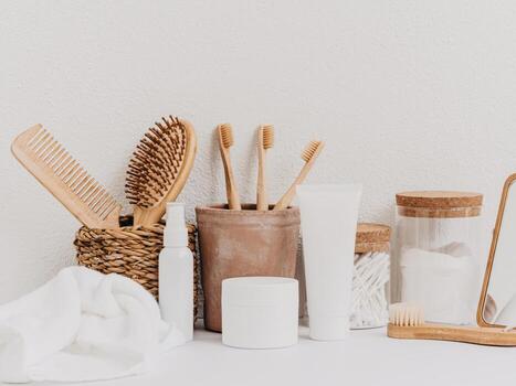 Bath background front view with straw box, container with toothbrushes, cosmetics photo