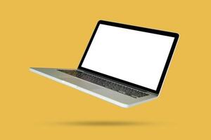 Laptop with blank screen isolated on yellow background photo