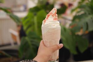 Strawberry milkshake with whipped cream photo