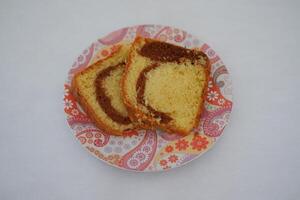 sponge cake on a plate with white background photo