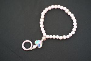 A beaded bracelet on a black surface. photo