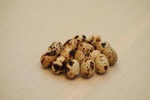 Quail eggs on a wooden table. Close-up, selective focus photo