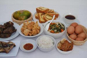 traditional Indonesian food arranged neatly on a white surface photo