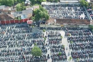 A large parking lot filled with rows of motorbikes photo