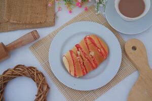 Strawberry bread with chocolate drink on white background photo
