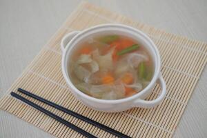 Creamy soup in a white bowl photo