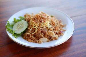 seafood fried rice with egg on wooden table photo