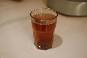 hot tea in glass on table. Selective focus and shallow depth of field. photo