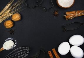 Ingredients for baking on a black background. Baking or cooking background. Top view. Copy space. photo