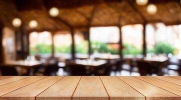 Empty wooden table top with lights bokeh on blur restaurant background. photo
