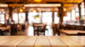 Empty wooden table top with lights bokeh on blur restaurant background. photo