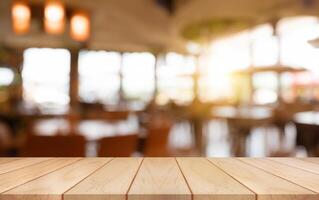 Empty wooden table top with lights bokeh on blur restaurant background. photo