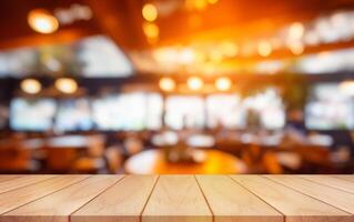 Empty wooden table top with lights bokeh on blur restaurant background. photo