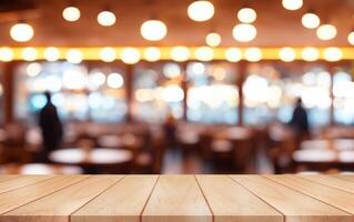 Empty wooden table top with lights bokeh on blur restaurant background. photo