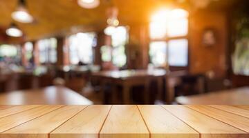 Empty wooden table top with lights bokeh on blur restaurant background. photo