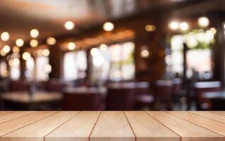 Empty wooden table top with lights bokeh on blur restaurant background. photo