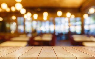 Empty wooden table top with lights bokeh on blur restaurant background. photo