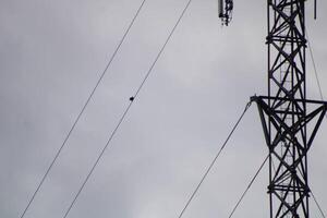 Telecommunications Tower High IN The Sky With A Cloudy Sky Background photo