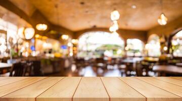 Empty wooden table top with lights bokeh on blur restaurant background. photo