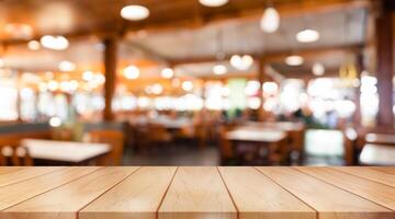 Empty wooden table top with lights bokeh on blur restaurant background. photo