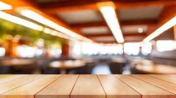 Empty wooden table top with lights bokeh on blur restaurant background. photo
