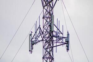 Telecommunications Tower High IN The Sky With A Cloudy Sky Background photo