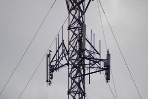 Telecommunications Tower High IN The Sky With A Cloudy Sky Background photo