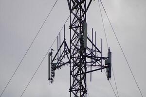 Telecommunications Tower High IN The Sky With A Cloudy Sky Background photo