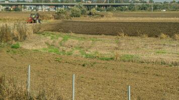 Agricultural fields with young green shoots of grain crops and plowed field without sowing. With trees in the background on the hills. Fallow concept. Alternation. photo