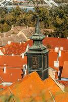 cityscape of Novi Sad from the historic vantage point of Petrovaradin, where ancient towers and charming streets intertwine with the gentle flow of the Danube. photo