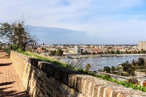 cityscape of Novi Sad from the historic vantage point of Petrovaradin, where ancient towers and charming streets intertwine with the gentle flow of the Danube. photo