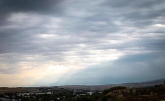 Overcast sky with dark clouds. Dark sky before a thunder-storm. The gray cloud background before rain. photo