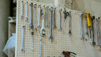 Various tools. file, screwdriver, hammer, pliers, garden tools are displayed on wooden shelf inside rustic garage or manufactory, workshop studio in a rustic garden house. Hobby, leasure activity. High quality photo