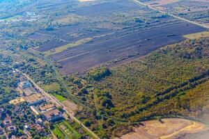 Aerial view of valley with farm fields, pond and Danube river. High quality photo
