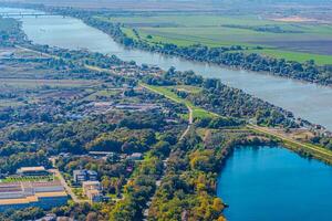 Aerial view of valley with farm fields, pond and Danube river. High quality photo