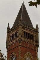 Brick Tower with Arched Windows and Slate Roof in Manchester photo