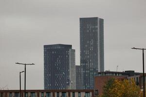 Three Grey Buildings Against a Hazy Sky in Manchester photo