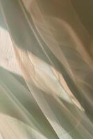 Soft play of light and shadow on translucent curtains in pastel tones evokes calm and serenity photo