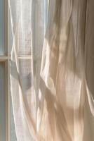 Soft play of light and shadow on translucent curtains in pastel tones evokes calm and serenity photo