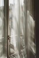 Soft play of light and shadow on translucent curtains in pastel tones evokes calm and serenity photo