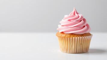 Delicious pink frosted cupcake on white background - sweet dessert close-up photo