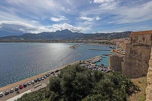 View from the fortress of Calvi in Corsica overlooking the coastline and the sea with mountains photo