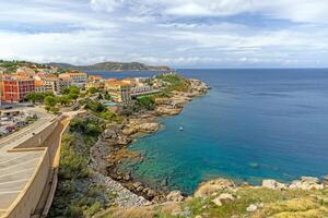View from the fortress of Calvi in Corsica overlooking the coastline and the sea with mountains photo