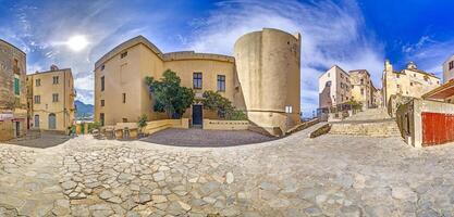 Scene from the historic old town of Calvi in Corsica with cobblestone streets and rustic buildings photo