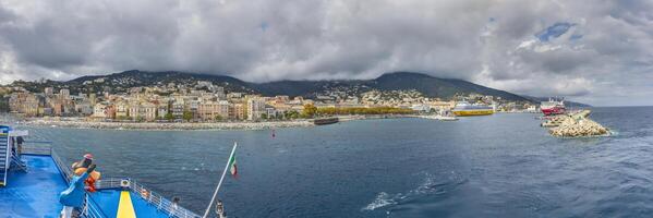 Panoramic view of Bastia Corsica from the sea with colorful buildings under dramatic cloudy skies photo