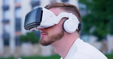 A man wearing a white shirt and a pair of virtual reality glasses video