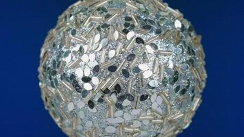 A large glass ball with silver and white dots video