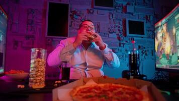 A man eating pizza while playing games video