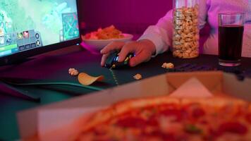 A person playing games on a computer with a pizza video